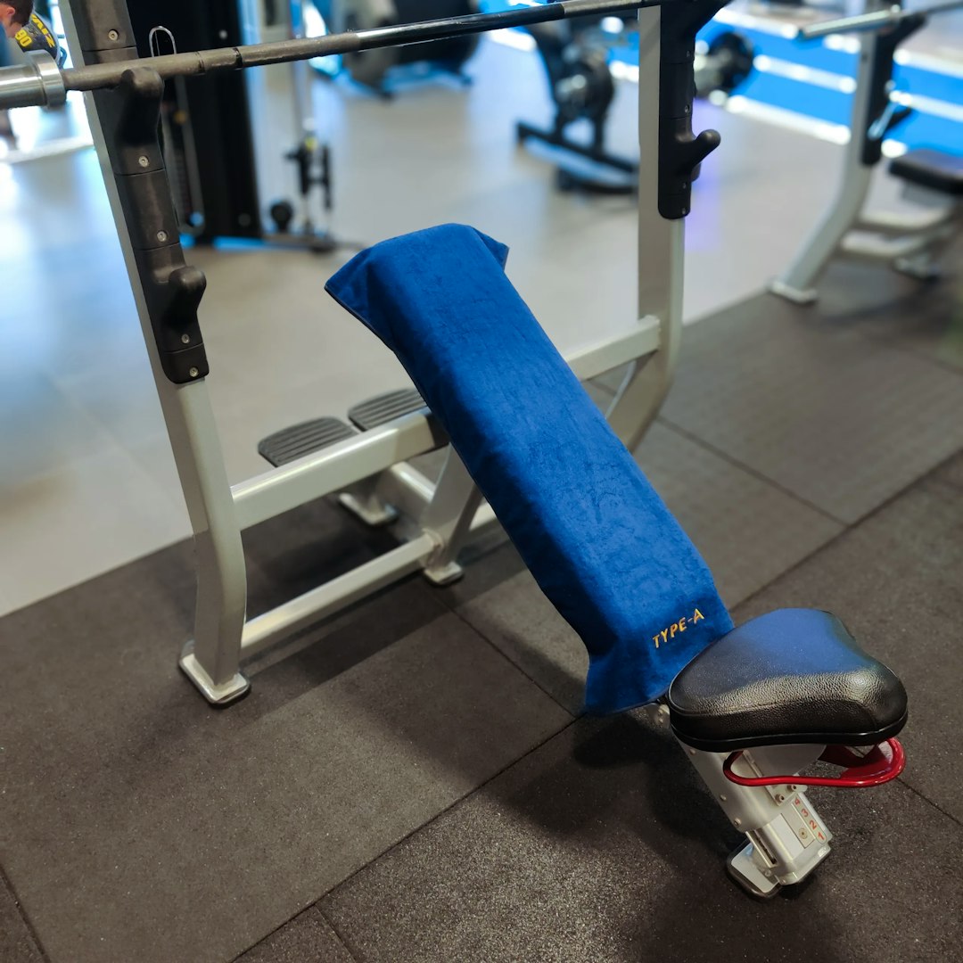 Type-A Gym Towel on a angled bench side view, showing the size and logo.