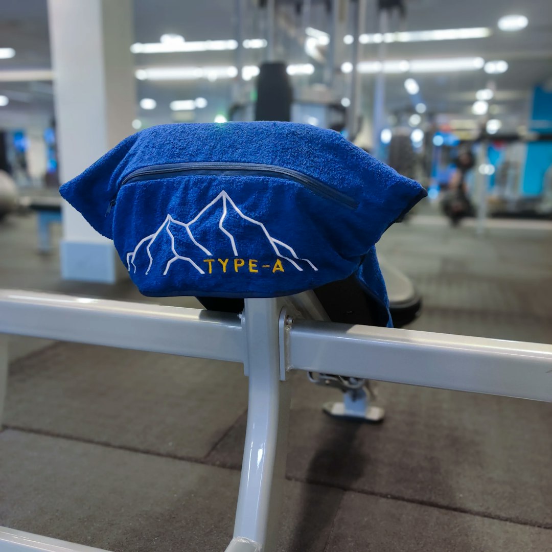 Type-A Gym Towel on a angled bench viewing the pocket and zipper features.